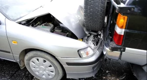 Car accident lawyer consulting with a client in an office setting, with legal documents and a laptop visible on the table.