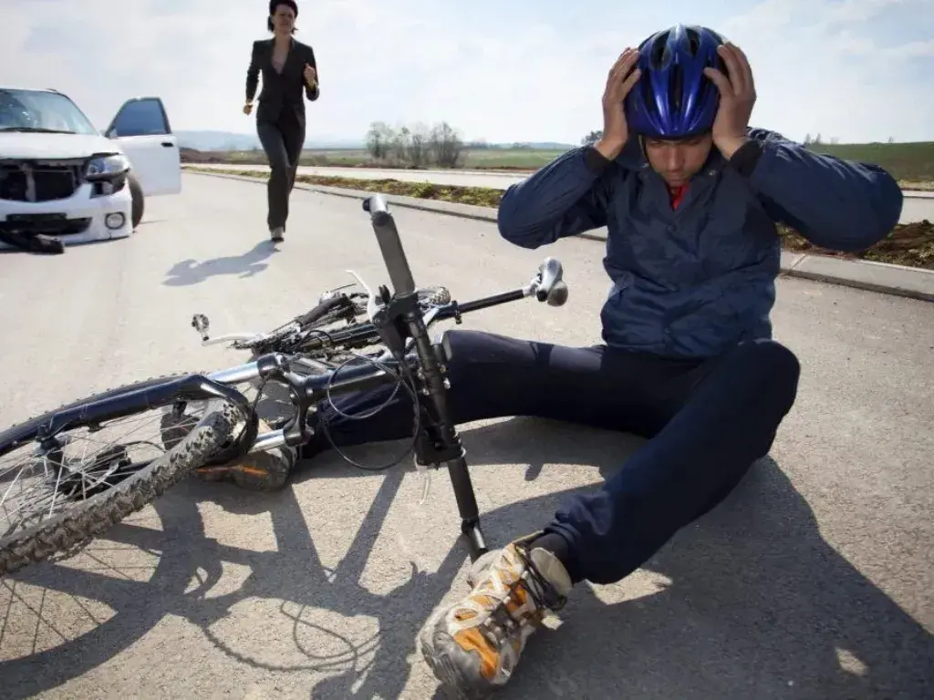 bicycle accident scenario which includes collision with a car, falling off the bike, and injuries sustained by cyclists